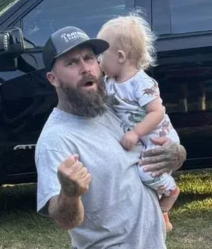 Daniel Vowell with his infant son