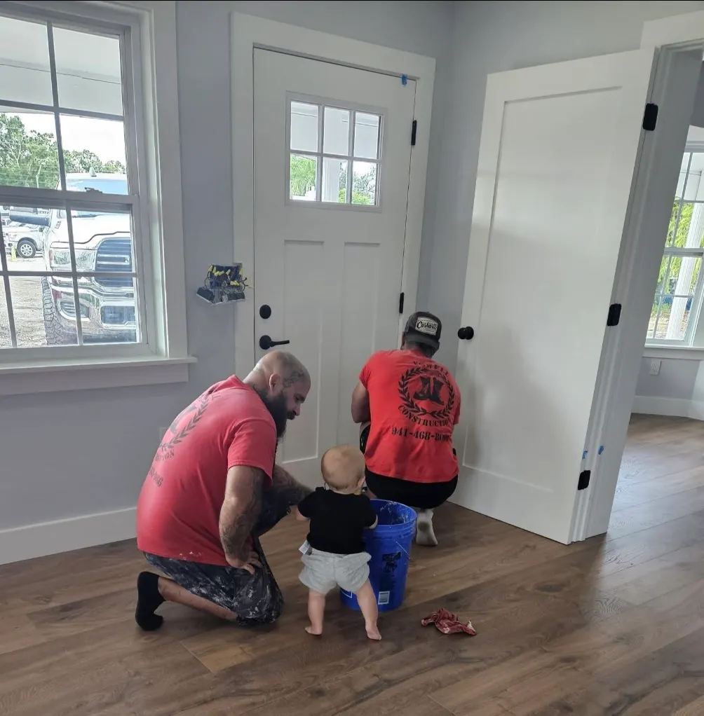 Daniel Vowell showing his son his work